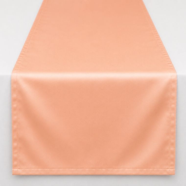 A peach-colored satin table runner with a subtle sheen, shown draped over a white surface against a light gray background.