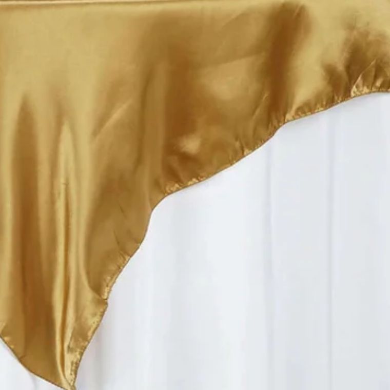 Gold satin tablecloth overlay with elegant folds